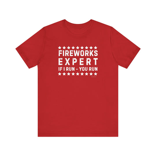 A Firework Expert Tee, a red shirt with white text, in XS-3XL sizes. 100% Airlume combed cotton, retail fit, tear away label, ribbed knit collars, taping on shoulders, dual side seams for shape retention.
