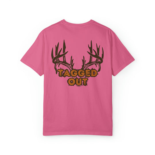 A pink shirt featuring antlers and text, the Tagged Out Tee from Worlds Worst Tees. Unisex, garment-dyed sweatshirt made of 80% ring-spun cotton and 20% polyester, with a relaxed fit and rolled-forward shoulder.