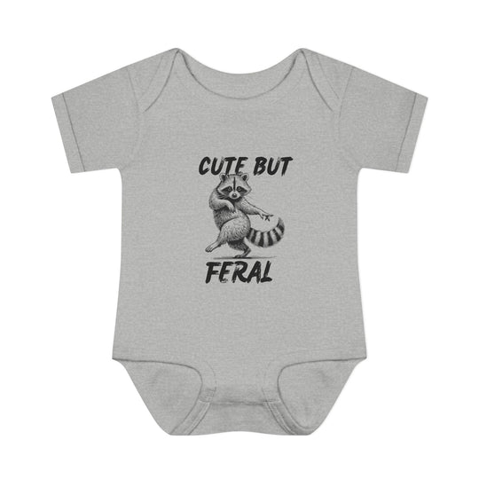 Heather-gray Cute But Feral baby onesie with a playful raccoon illustration, designed for comfort with soft ring-spun cotton and convenient lap shoulders.