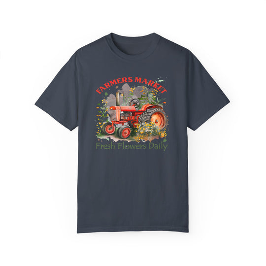 A relaxed fit Fresh Flowers Tee featuring a tractor and flowers design on soft ring-spun cotton. Garment-dyed for extra coziness, with durable double-needle stitching and a seamless tubular shape.