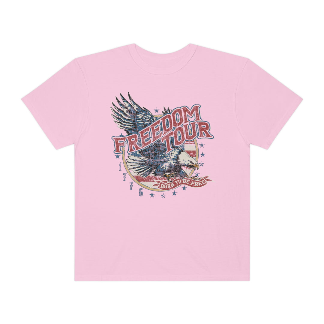 A pink Freedom Tour Tee, featuring a graphic eagle design on ring-spun cotton. Relaxed fit, double-needle stitching, and seamless sides for durability and comfort. From Worlds Worst Tees.