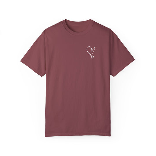 A red t-shirt featuring a heart and stethoscope design. Made of 100% ring-spun cotton with a relaxed fit for everyday comfort. Double-needle stitching for durability, no side-seams for a tubular shape.