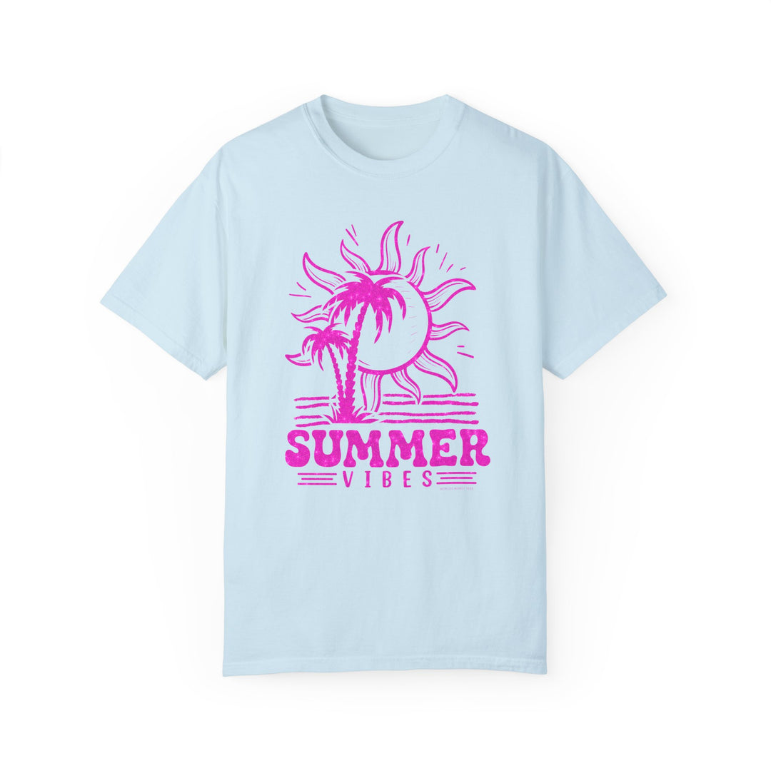 A garment-dyed Summer Vibes Tee in ring-spun cotton, featuring a pink sun and palm tree design. Relaxed fit, double-needle stitching, and seamless sides for durability and comfort. From Worlds Worst Tees.