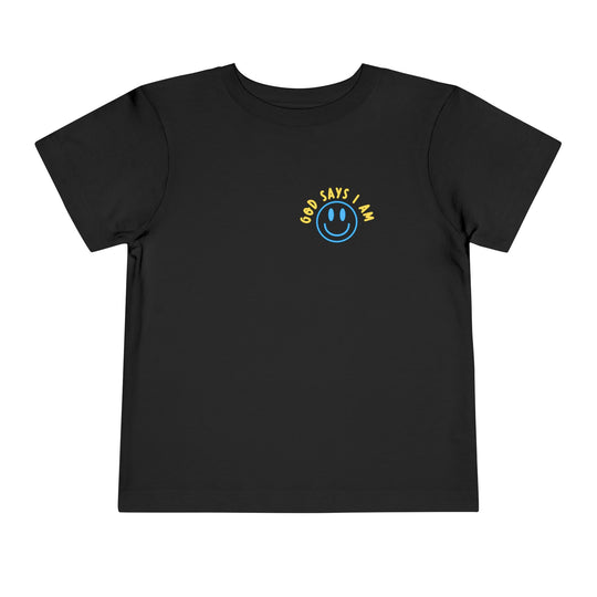 I AM Toddler Tee: Plain black with a blue smiley-face and “GOD SAYS I AM” in yellow. Made from soft Airlume cotton for comfort.