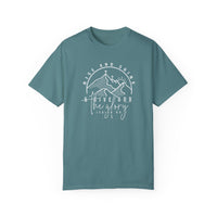A relaxed fit Rise and Shine Tee, a garment-dyed t-shirt in blue with a graphic design. Made of 100% ring-spun cotton for coziness, featuring double-needle stitching for durability. Sizes from S to 4XL.