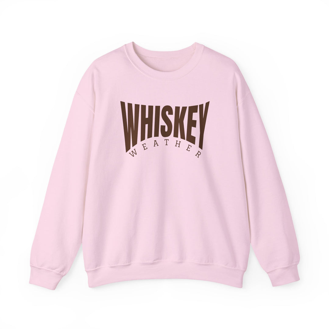 Light pink crewneck sweatshirt with WHISKEY in bold brown and WEATHER smaller beneath. Comfortable, unisex fit with durable stitching and sustainable materials.