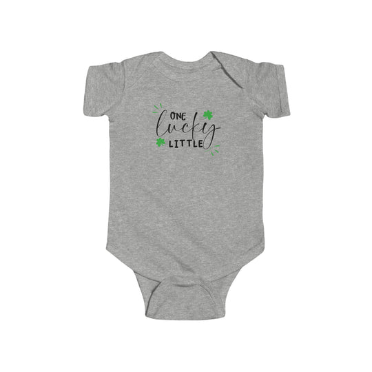 A durable and soft infant bodysuit, the One Lucky Little Onesie by Worlds Worst Tees features green shamrocks and black text. Made of 100% cotton, with ribbed knit bindings and plastic snaps for easy changing.