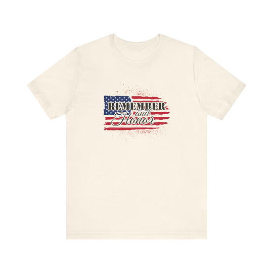 A white t-shirt featuring a flag and text, the Remember and Honor Tee from Worlds Worst Tees. Unisex jersey tee with ribbed knit collars, taping on shoulders, and 100% Airlume combed cotton. Sizes XS to 3XL.