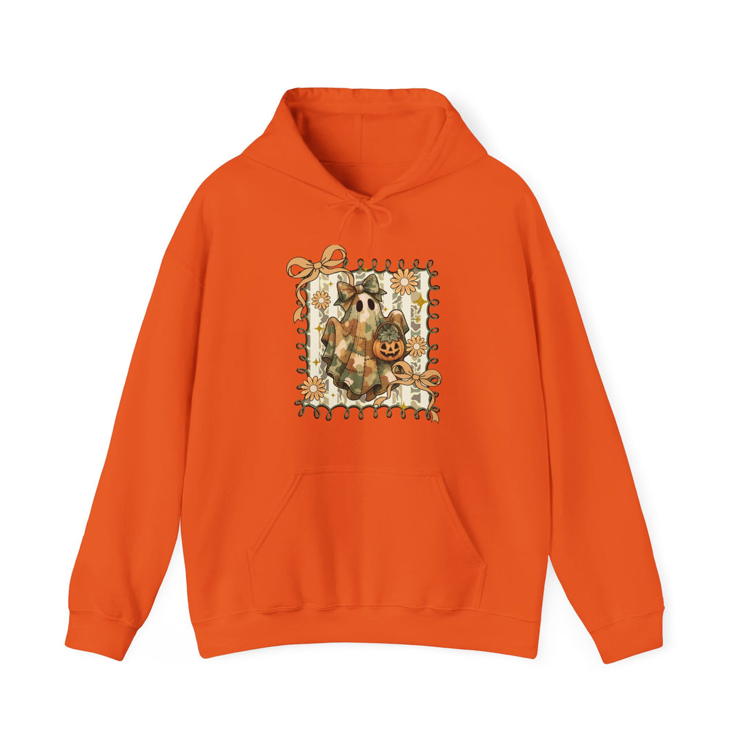 Orange Quilted Ghost Hoodie featuring a ghost in camo with a bow and jack-o’-lantern, framed by ribbon swirls and daisies. Cozy blend with a kangaroo pocket.