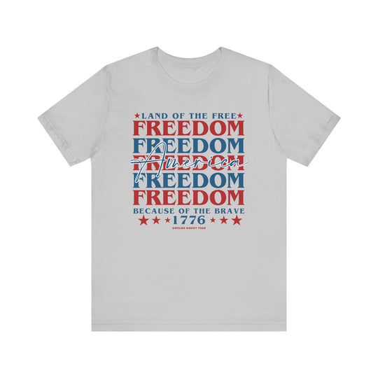 American Freedom Tee: Unisex white t-shirt with red and blue text. Soft cotton, ribbed knit collars, taping on shoulders for better fit, and dual side seams for shape retention. 100% Airlume combed and ringspun cotton.