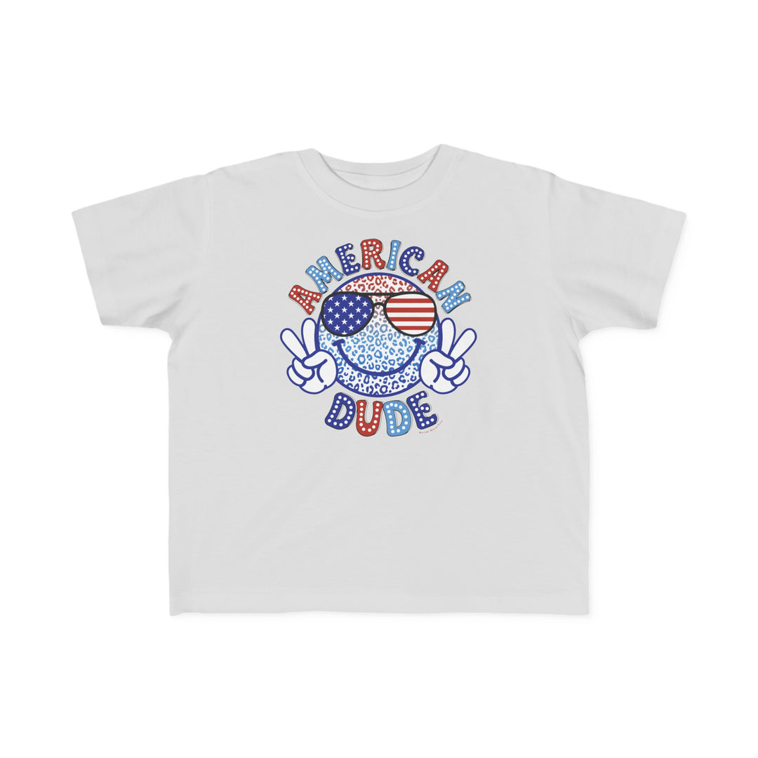 American Dude Toddler Tee featuring a cartoon character with sunglasses, a peace sign hand gesture, and a colorful background. Soft 100% combed ringspun cotton, light fabric, tear-away label, classic fit. Sizes 2T to 5-6T.