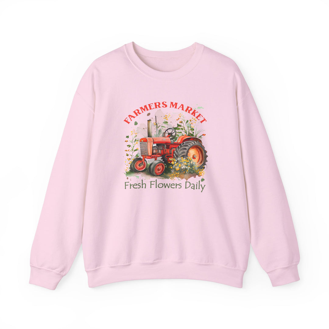 A pink sweatshirt featuring a tractor design, part of the Fresh Flowers Crew collection by Worlds Worst Tees. Unisex heavy blend crewneck with ribbed knit collar, polyester-cotton fabric, and no itchy side seams.