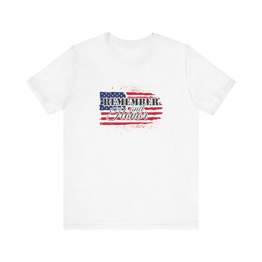 A white unisex jersey tee featuring a flag and text design. Made of 100% Airlume combed cotton, with ribbed knit collars and taping on shoulders for durability. Retail fit, tear away label, and true-to-size fit.