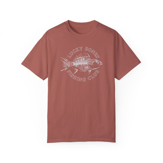 A red Lucky Bones Fishing Club Tee with a fish design on ring-spun cotton. Medium weight, relaxed fit, durable double-needle stitching, and seamless sides for comfort. From Worlds Worst Tees.