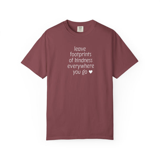 Muted maroon Leave Kindness Tee with white text and heart on chest, short-sleeved, crewneck, laid flat. Features Comfort Colors brand tag.
