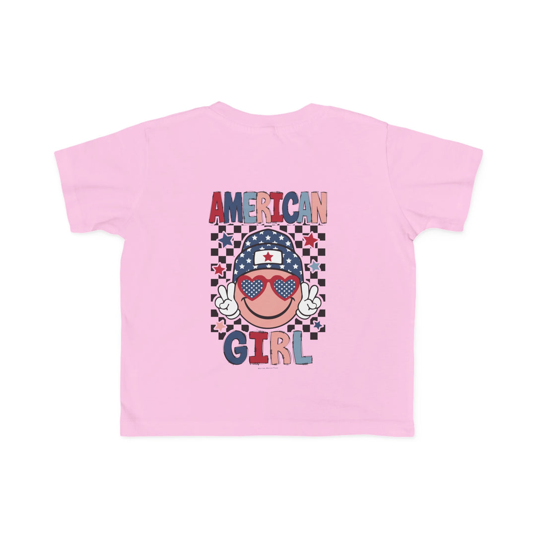 American Girl Toddler Tee featuring a pink shirt with a cartoon character, ideal for sensitive skin. 100% combed ringspun cotton, light fabric, tear-away label, and classic fit. Sizes: 2T, 3T, 4T, 5-6T.