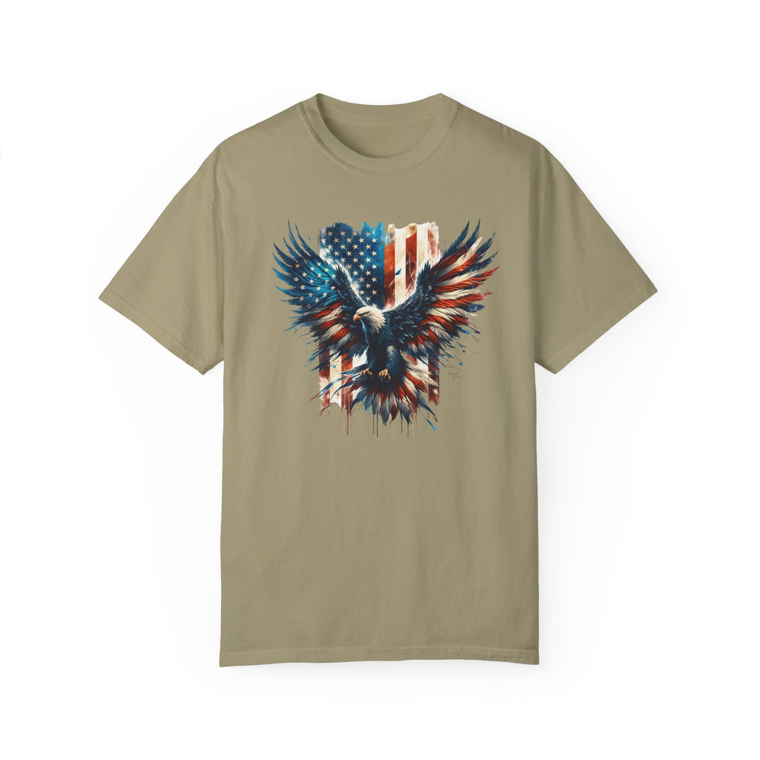 American Eagle Tee: A tan t-shirt featuring a picture of an eagle and flag. 100% ring-spun cotton, medium weight, relaxed fit for daily comfort. Durable double-needle stitching, no side-seams for a tubular shape.
