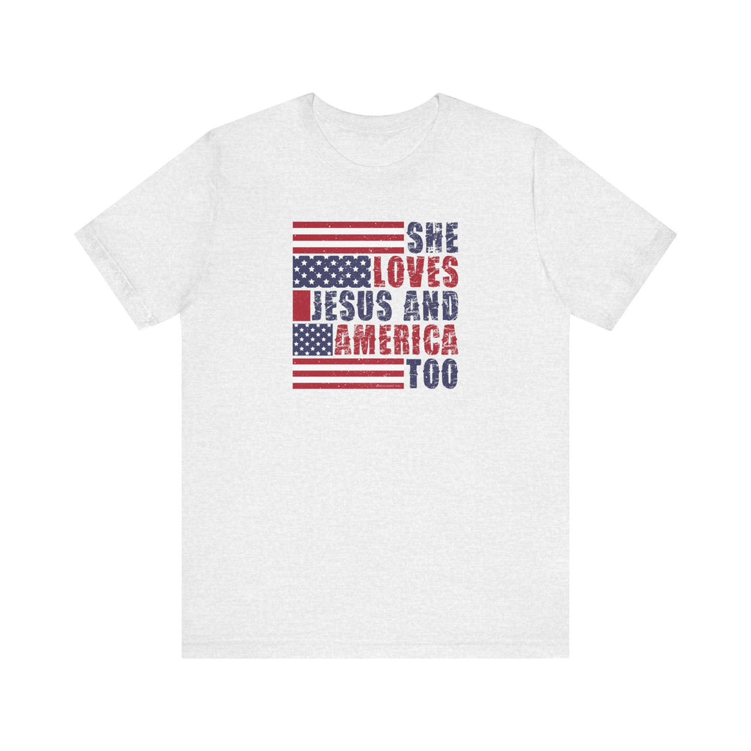 A beloved She Loves Jesus and America Tee, a white shirt with red and blue text. Unisex jersey tee with ribbed knit collars, taping on shoulders, and tear-away label. 100% Airlume combed cotton, retail fit.