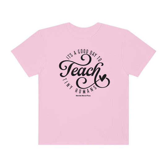 Unisex Teach Tiny Humans Tee: Pink shirt with black text, relaxed fit, ring-spun cotton blend, medium-heavy fabric. Ideal for comfort and style. From Worlds Worst Tees.