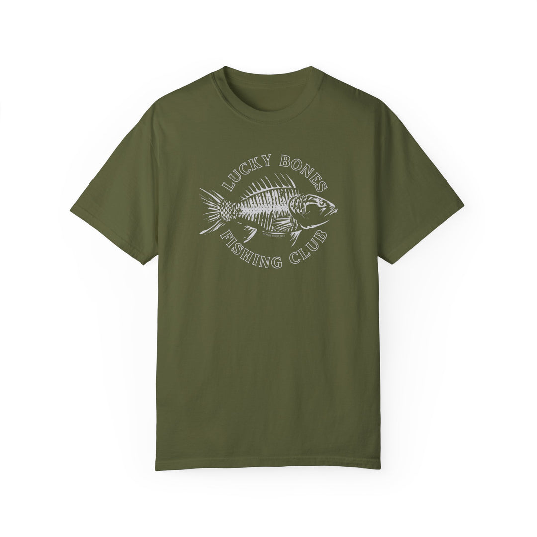 A Lucky Bones Fishing Club Tee, featuring a fish design on a green t-shirt. 100% ring-spun cotton, garment-dyed for coziness, with a relaxed fit and durable double-needle stitching. Sizes from S to 3XL.