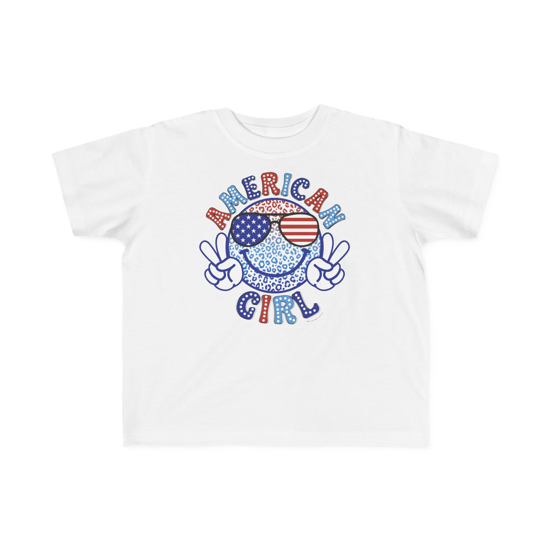 American Girl Toddler Tee featuring a cartoon character with sunglasses and peace sign on a white shirt. Soft 100% combed ringspun cotton, tear-away label, and classic fit for toddlers. Sizes from 2T to 5-6T.