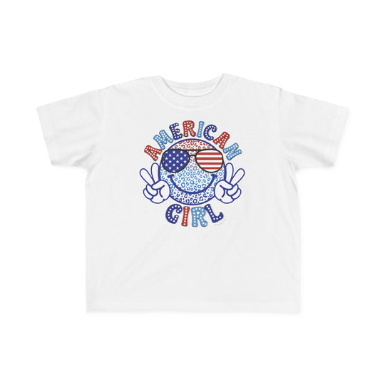 American Girl Toddler Tee featuring a cartoon character with sunglasses and peace sign on a white shirt. Soft 100% combed ringspun cotton, tear-away label, and classic fit for toddlers. Sizes from 2T to 5-6T.