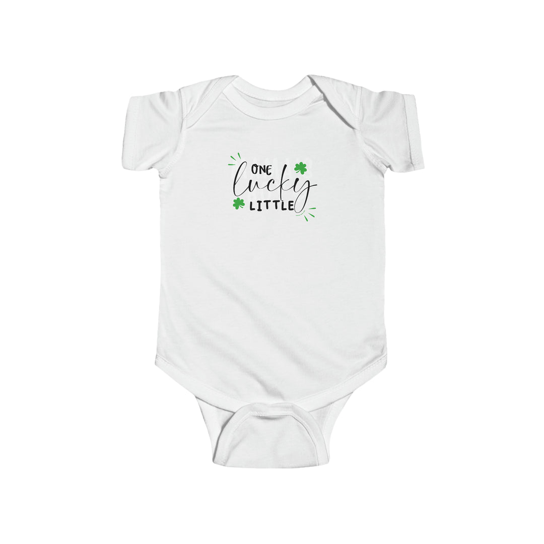 A white baby bodysuit with black text, featuring One Lucky Little Onesie design. 100% cotton fabric, ribbed knitting bindings, and plastic snaps for easy changing. From Worlds Worst Tees.