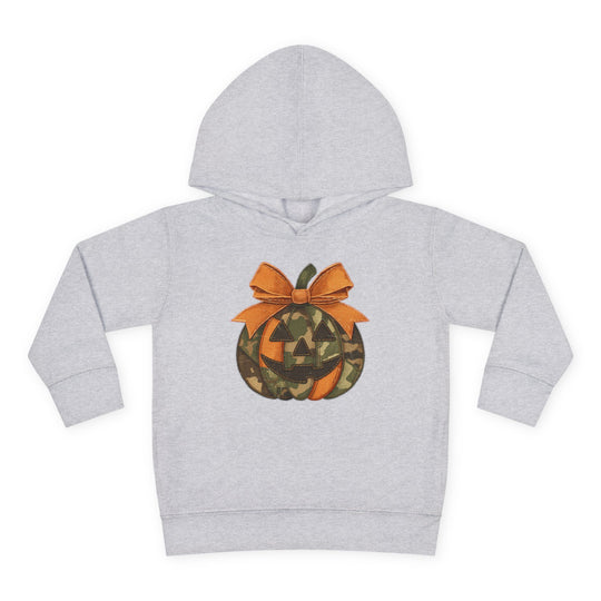 Jackie O Toddler Hoodie: Light-gray children's sweatshirt with a jack-o’-lantern graphic featuring orange and camouflage panels, topped with a large orange bow.
