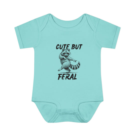 Light teal onesie features a sassy raccoon graphic with Cute But Feral slogan, ideal for infants. Soft, ring-spun cotton ensures comfort.