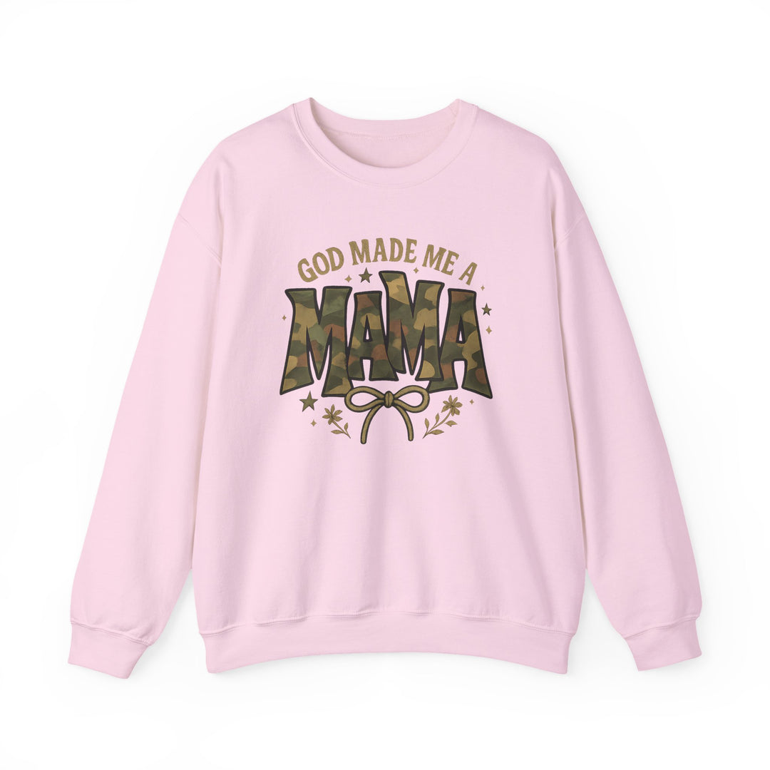 Light-pink sweatshirt with GOD MADE ME A MAMA graphic, featuring camouflage MAMA text, bow, stars, and floral accents; cozy, durable crewneck from Worlds Worst Tees.
