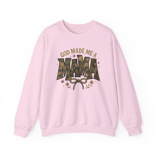Light-pink sweatshirt with GOD MADE ME A MAMA graphic, featuring camouflage MAMA text, bow, stars, and floral accents; cozy, durable crewneck from Worlds Worst Tees.