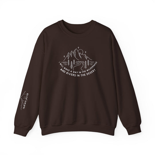 A brown crewneck sweatshirt with white text, featuring a mountain and trees line drawing. Unisex heavy blend made of 50% cotton, 50% polyester for cozy comfort and durability. Ideal for colder months.