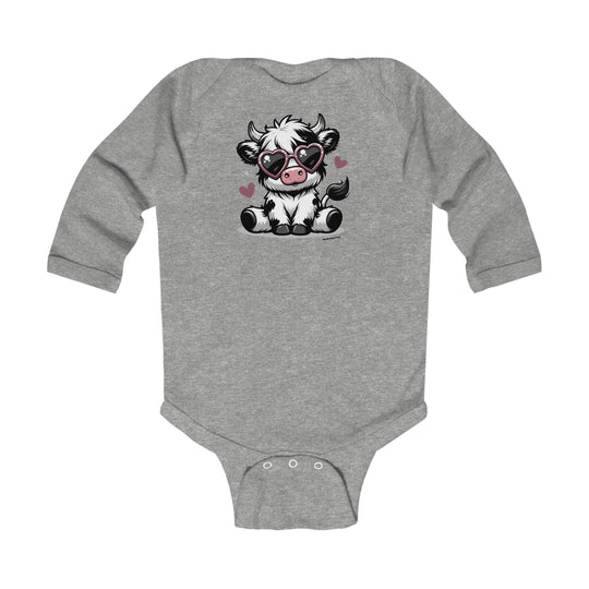 A cute cow-themed long sleeve onesie for infants from Worlds Worst Tees. Features a cartoon cow with sunglasses design on soft cotton fabric, plastic snaps for easy changing, and ribbed knitting for durability.