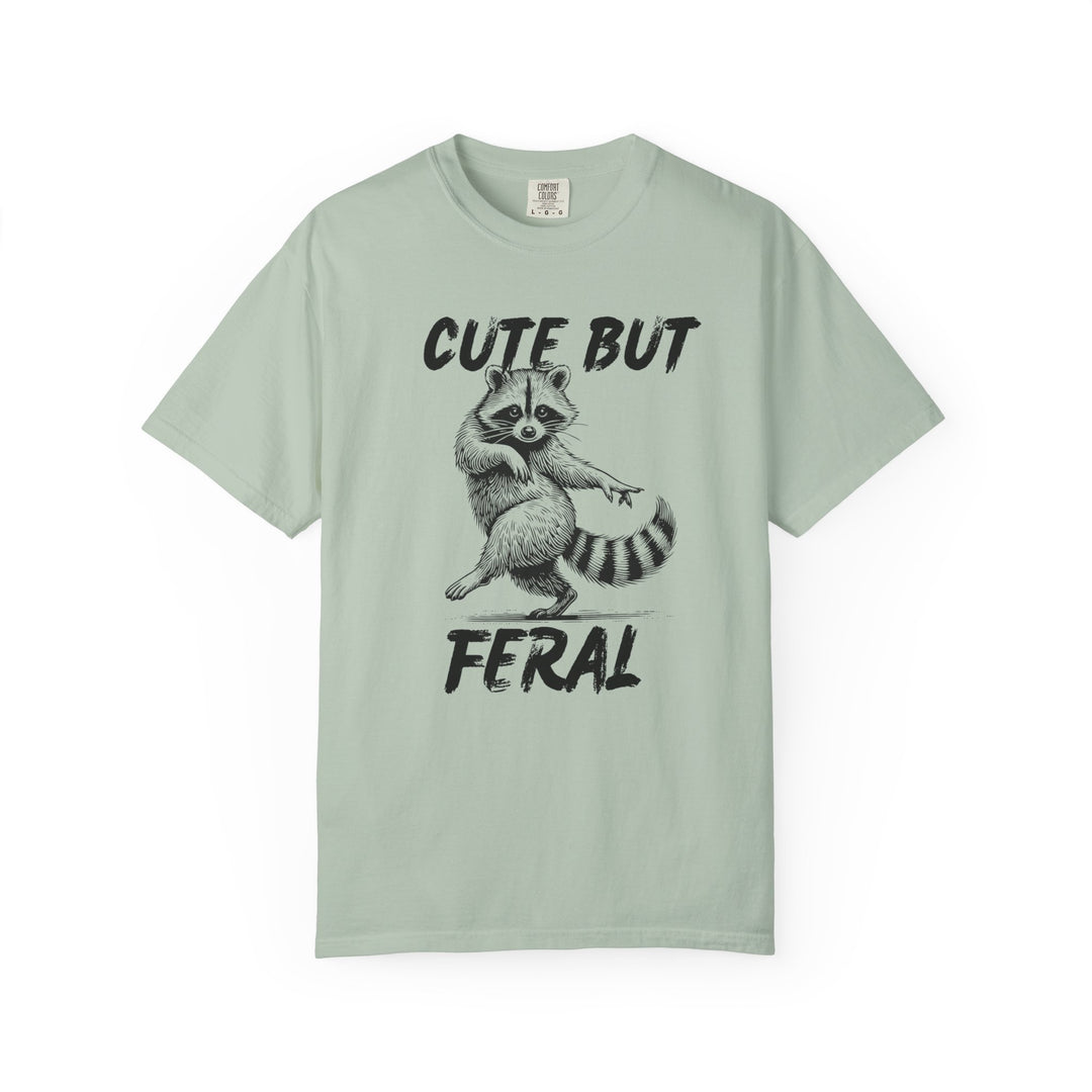 Cute but Feral Tee featuring a dancing raccoon and bold lettering, made from soft-washed ring-spun cotton for comfort and durability, ideal for casual wear.