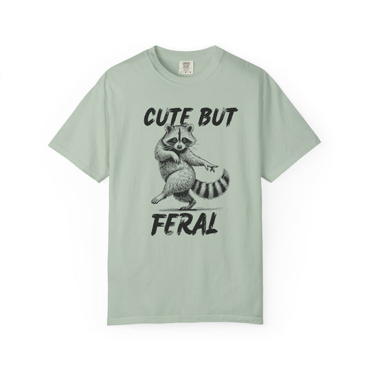 Cute but Feral Tee featuring a dancing raccoon and bold lettering, made from soft-washed ring-spun cotton for comfort and durability, ideal for casual wear.
