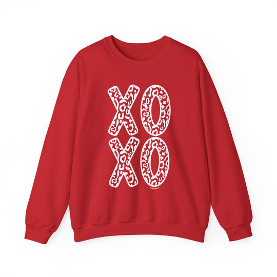Unisex XOXO Crew sweatshirt: Red with white letters, ribbed knit collar, 50% cotton, 50% polyester, loose fit, medium-heavy fabric, sewn-in label. Comfortable and stylish for any occasion.