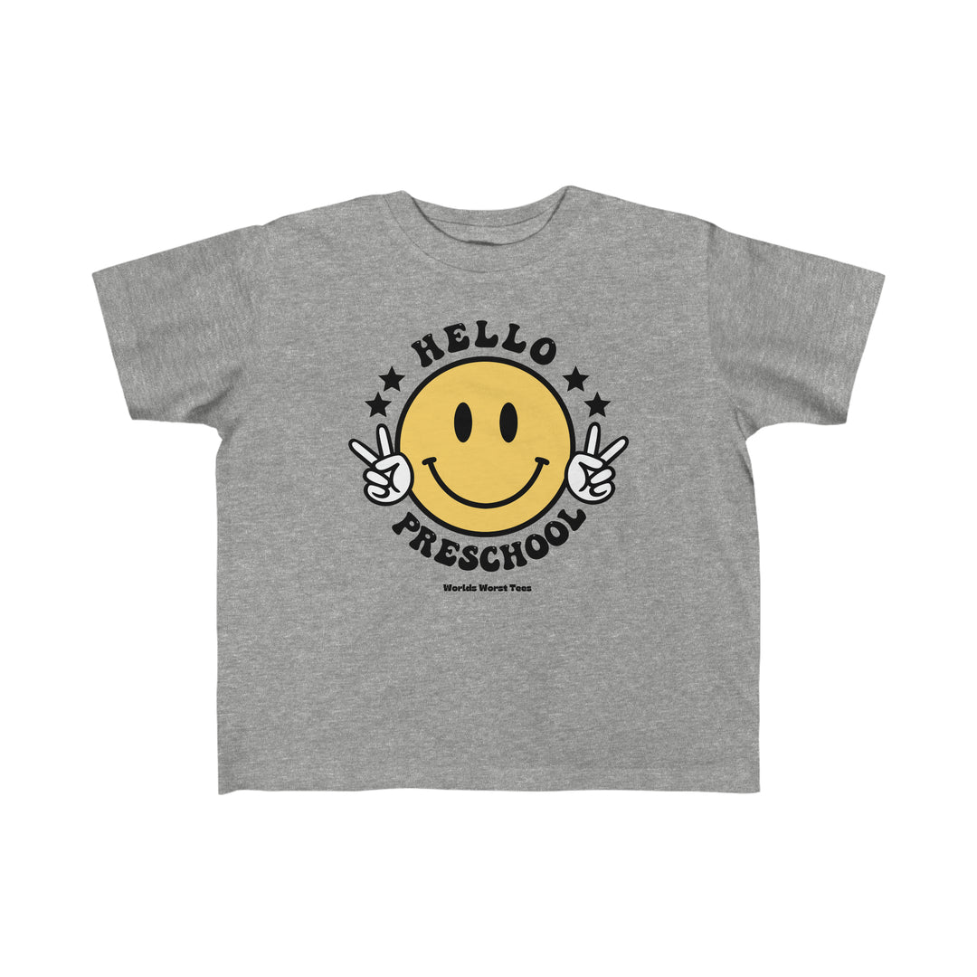 Hello Preschool Toddler Tee featuring a grey t-shirt with a yellow smiley face and peace sign hand gesture. Made of 100% combed ringspun cotton, light fabric, tear-away label, and a classic fit.