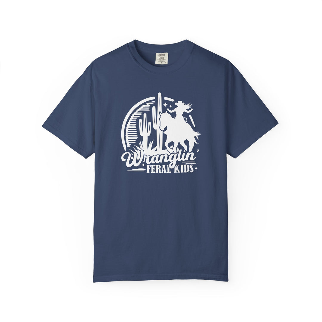 Wranglin' Feral Kids Tee: Navy-blue short-sleeve T-shirt featuring a desert scene with a horseback silhouette, cacti, stars, and text, crafted for comfort and durability.