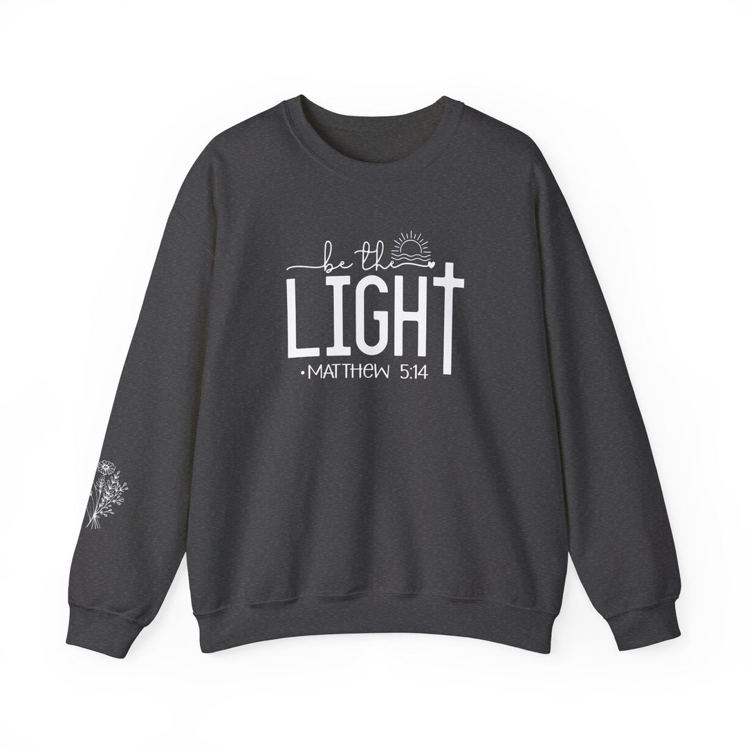 A unisex heavy blend crewneck sweatshirt, the Be the Light Crew, offers pure comfort with a ribbed knit collar and durable double-needle stitching. Made from 50% cotton and 50% polyester for coziness.