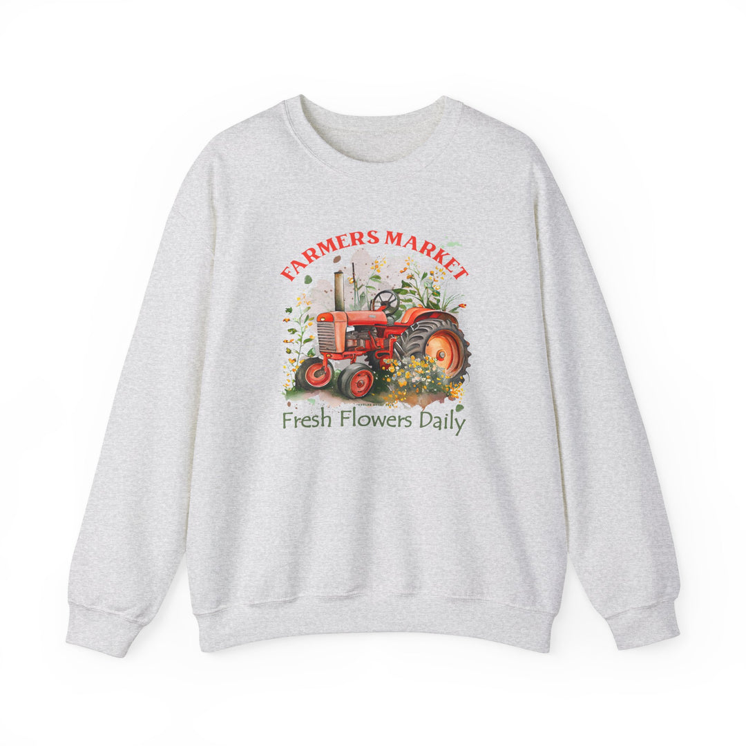 A white crewneck sweatshirt featuring a tractor design, ideal for all occasions. Made of 50% cotton and 50% polyester, with ribbed knit collar for lasting comfort. From Worlds Worst Tees, the Fresh Flowers Crew.