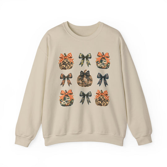 Bows and Pumpkins Crew: Light-beige sweatshirt with a 3x3 grid of camo and leopard-print pumpkins and bows, offering cozy comfort with durable, sustainable fabric.