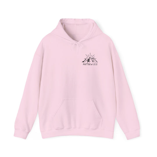 A pink unisex heavy blend hooded sweatshirt featuring a logo of mountains with sun rays. Made of 50% cotton and 50% polyester, this cozy hoodie offers a classic fit and a kangaroo pocket for practicality. Faith Can Move Mountains Hoodie by Worlds Worst Tees.