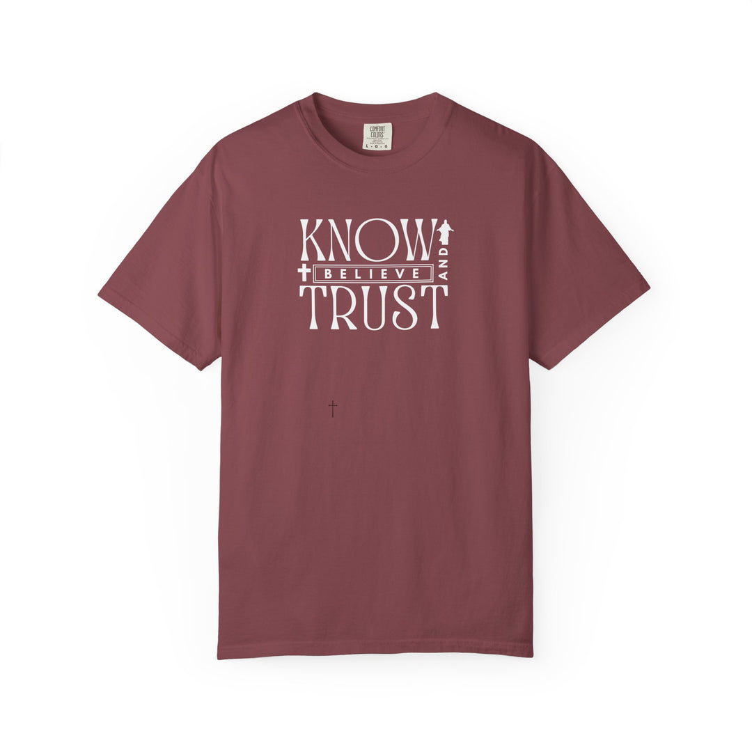 Know, Trust, Believe Tee from Worlds Worst Tees features bold white text on a red shirt, emphasizing comfort with a relaxed fit and durable stitching.