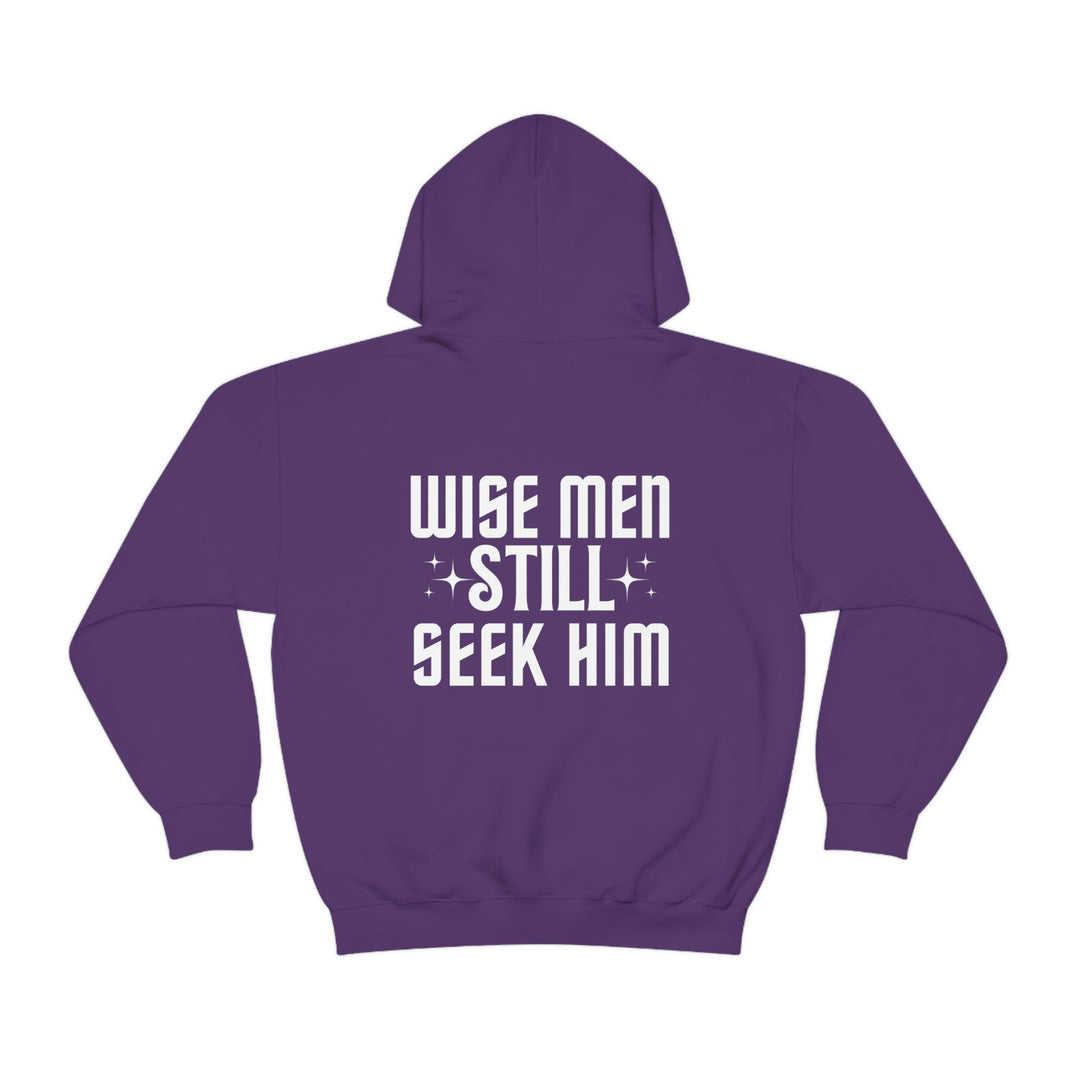 A purple hoodie with white text, featuring a spacious kangaroo pocket and drawstring hood. Unisex heavy blend of cotton and polyester, plush and warm for printing. Wise Men Still Seek Him Hoodie.