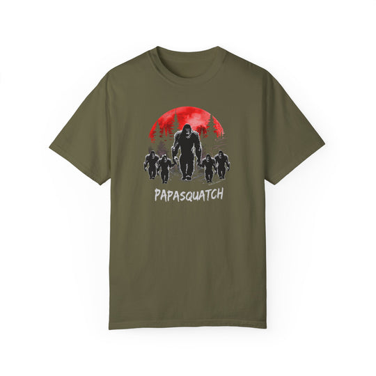 Papasquatch Tee: Green t-shirt featuring a large yeti, group of gorillas, and people. 100% ring-spun cotton, garment-dyed for coziness, with a relaxed fit and durable double-needle stitching. From Worlds Worst Tees.