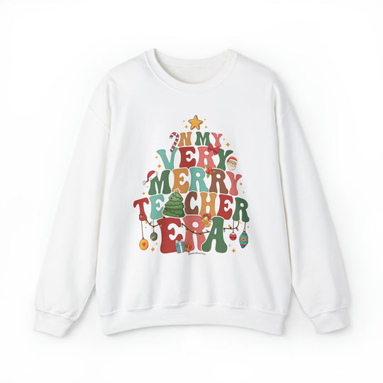 A unisex heavy blend crewneck sweatshirt featuring a Christmas tree graphic design. Made of 50% cotton and 50% polyester, with ribbed knit collar and no itchy side seams. Verry Merry Teacher Crew.