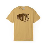 Hunting Season Tee: Muted mustard crew neck T-shirt with HUNTING SEASON in brown letters, offering relaxed fit and durable, soft-washed cotton fabric.