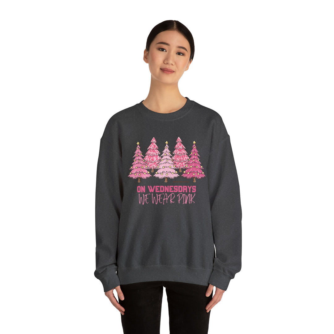 Unisex heavy blend crewneck sweatshirt featuring a woman in a grey sweater with pink trees. Comfortable, loose fit with ribbed knit collar. Made of 50% cotton, 50% polyester. Sewn-in label, true to size.
