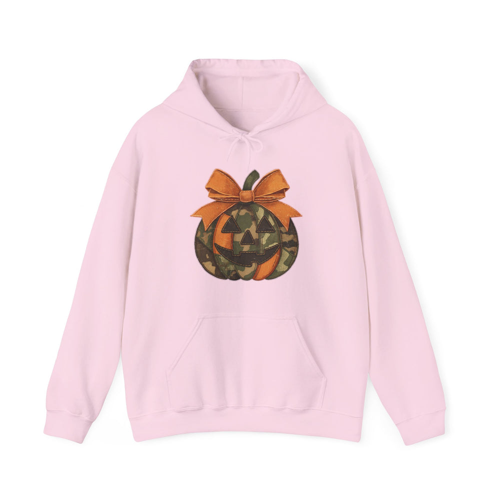 Light pink Copy of Jackie O Hoodie with a camouflage jack-o’-lantern design and orange bow, featuring a front pouch pocket and drawstring hood.