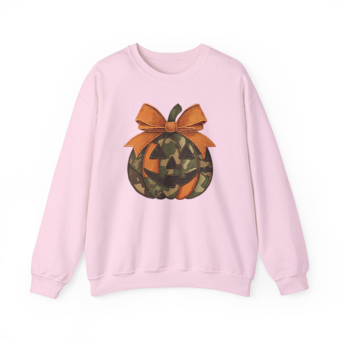 Light-pink Jackie O Crew sweatshirt with a patchwork jack-o’-lantern graphic and orange bow, offering a cozy fit and durable, unisex design.